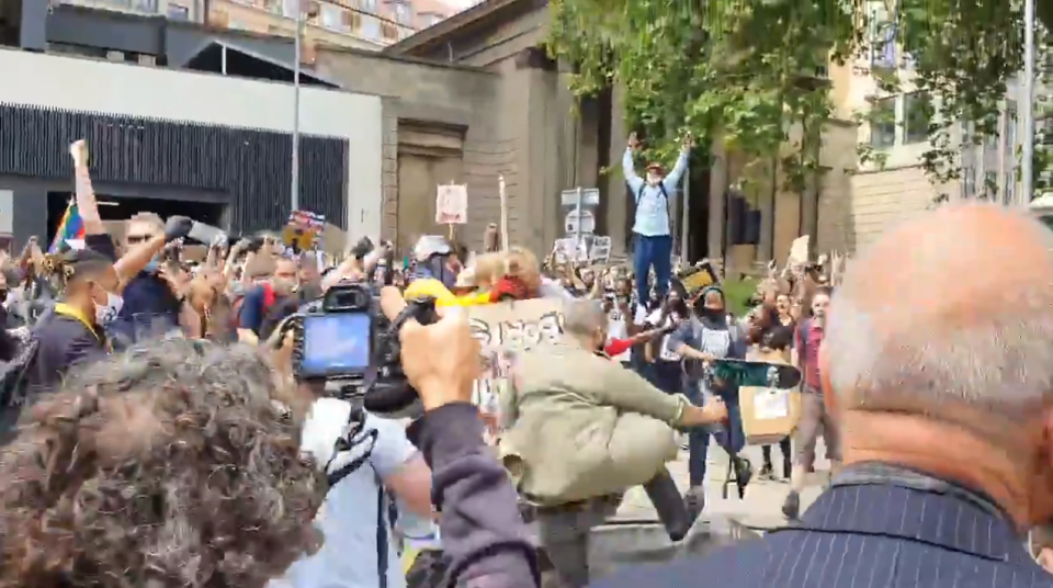  Protesters jump up and down on the statue today