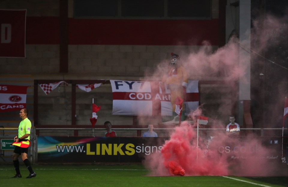 A fan of Fleetwood Town managed to halt the game by throwing a smoke bomb on to the pitch from over the stand