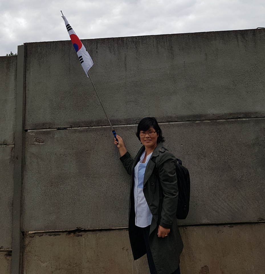 Jihyun with a South Korean flag - she dreamed of building a new life in a free country