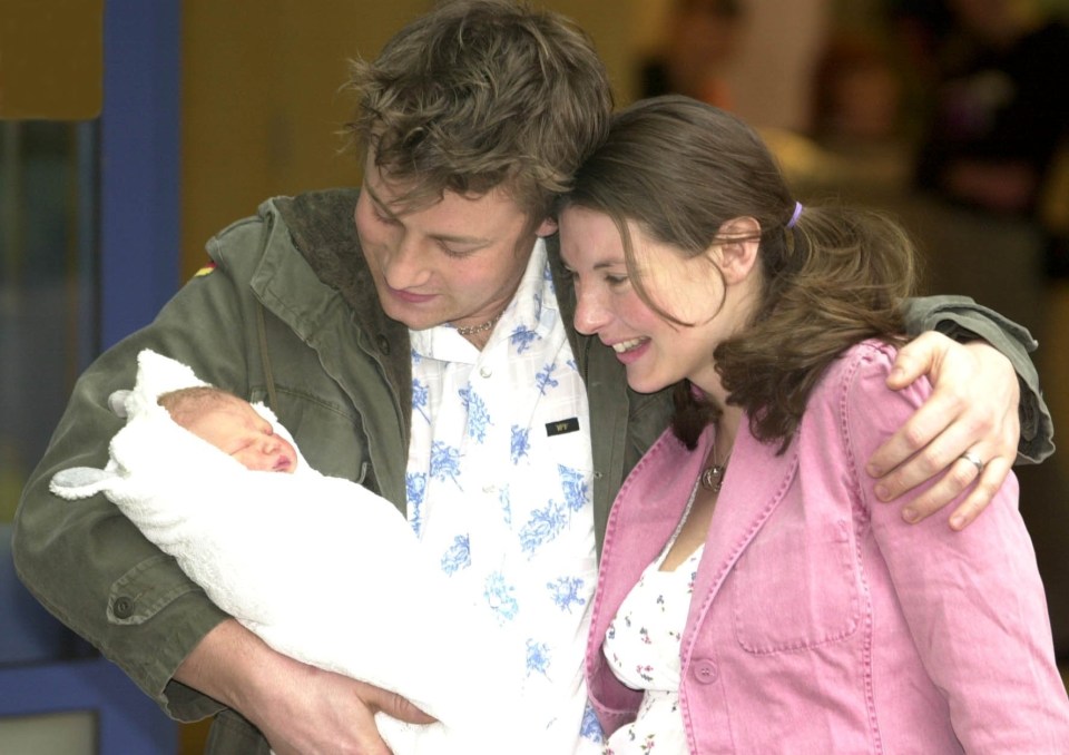 The couple leaving hospital with day-old daughter Poppy in 2002