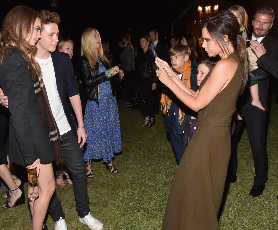 Victoria Beckham taking a snap of Cara and Brooklyn in Los Angeles