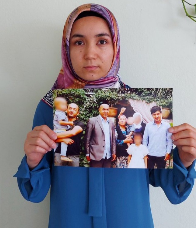 Marketing executive Nursimangul Abdurashid holds a picture of her Uighur family members, who have been detained by China