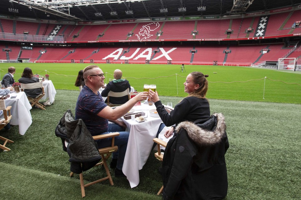 Ajax fans can eat their dinner at the side of the pitch in the stadium