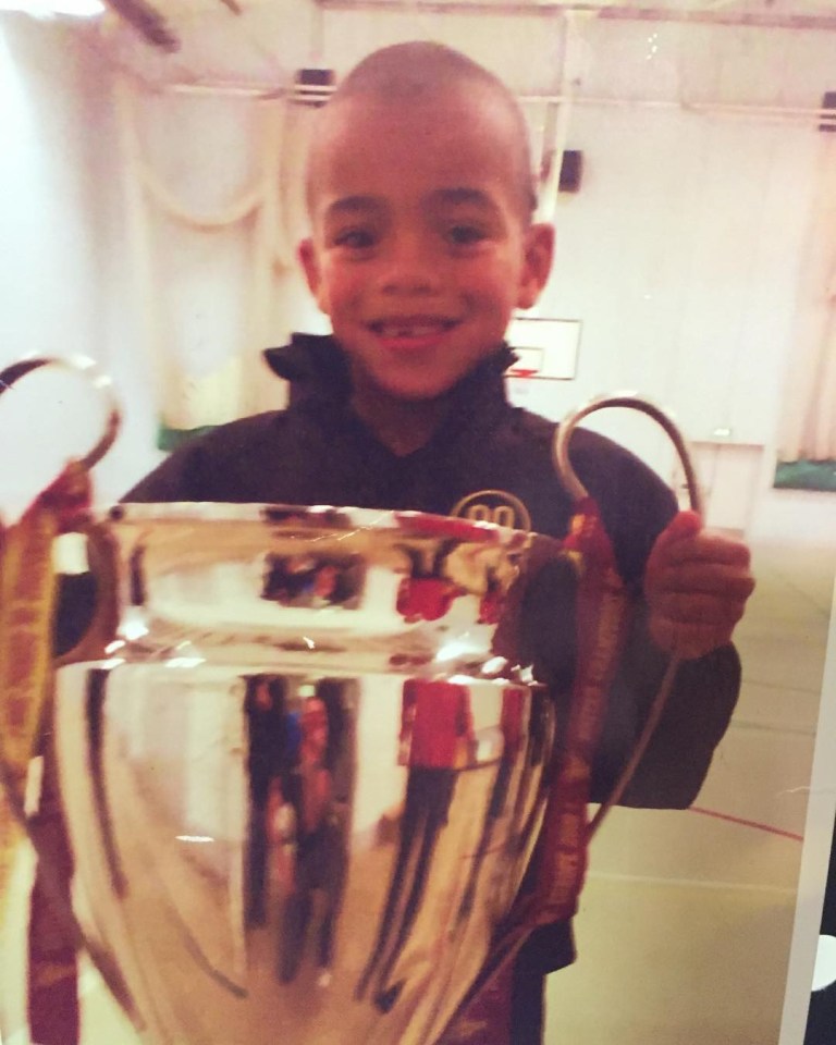 Mason with the Champions League trophy as a boy