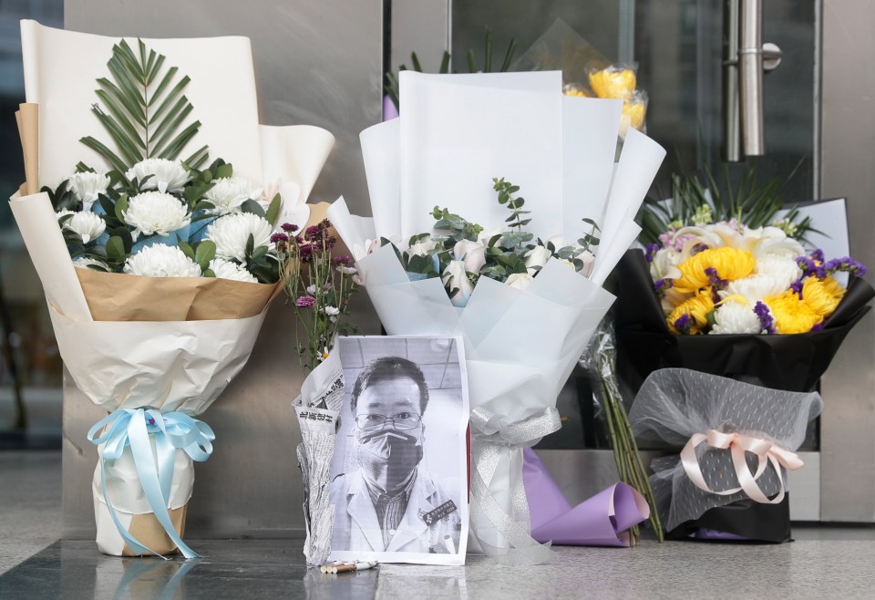 A floral tribute is laid following Dr. Li Wenliang's death