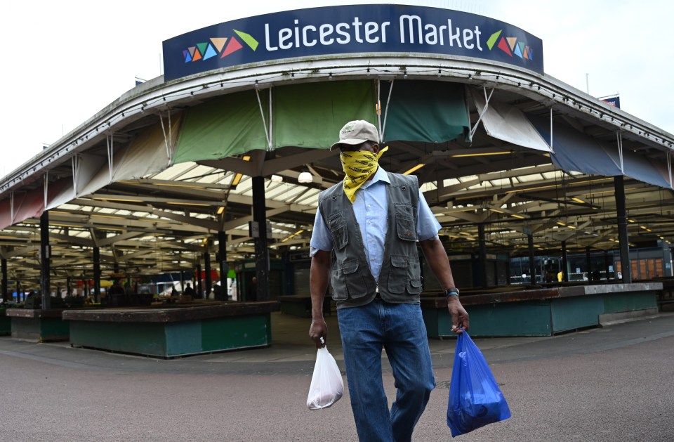 A masked shopper in Leicester - the first UK city to be forced into lockdown after virus restrictions were eased