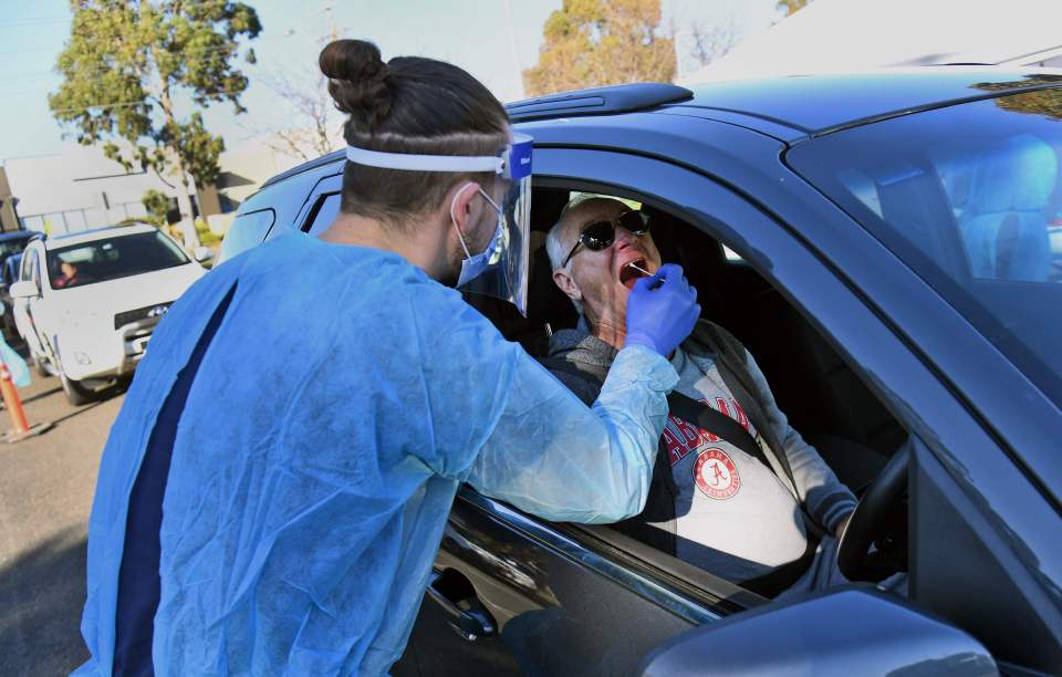 A man is tested for the coronavirus at a drive-thru centre in Melbourne