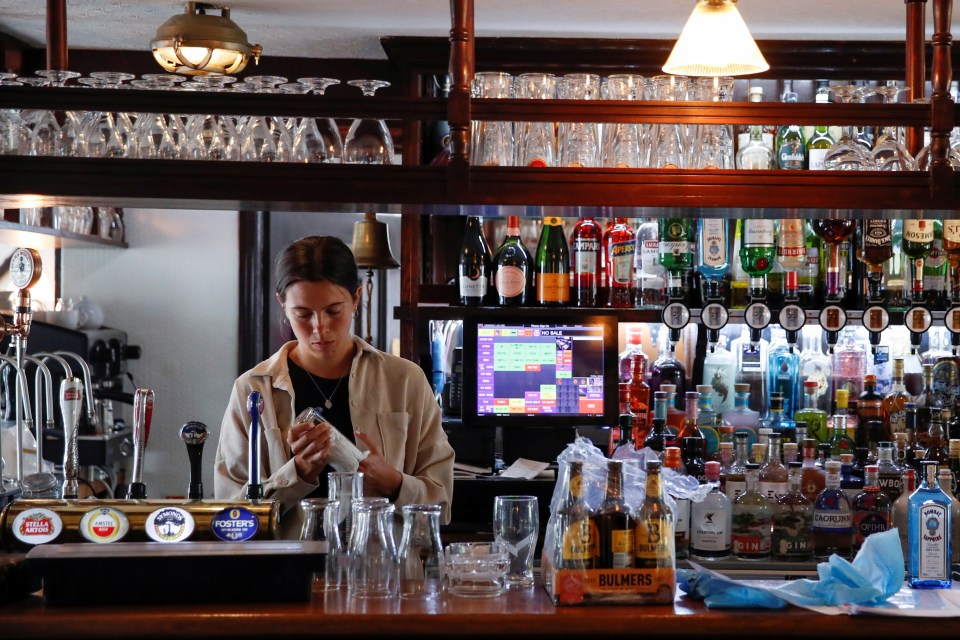 A staff member from The Millstream Pub cleans ahead of pubs reopening following the Covid-19 outbreak, in Hertford