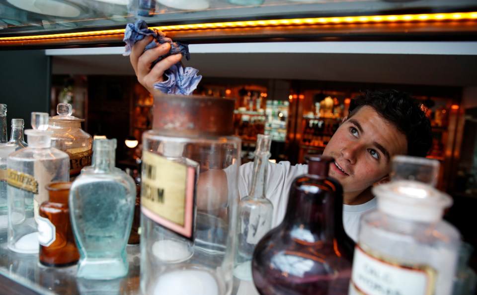 A staff member from The Practicioner pub cleans and prepares ahead of pubs reopening