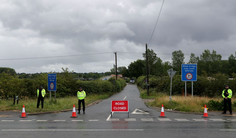 Cops stand on guard as jurors visit the spot where he died