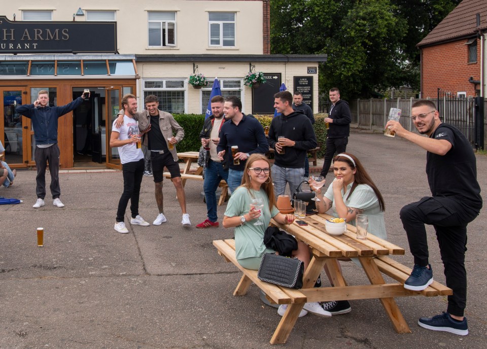 These revellers at the Berechurch Arms at Colchester in Essex were enjoying a drink in the sun