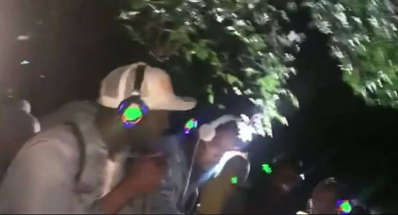 A man wearing a white cap appears to be DJ-ing the event