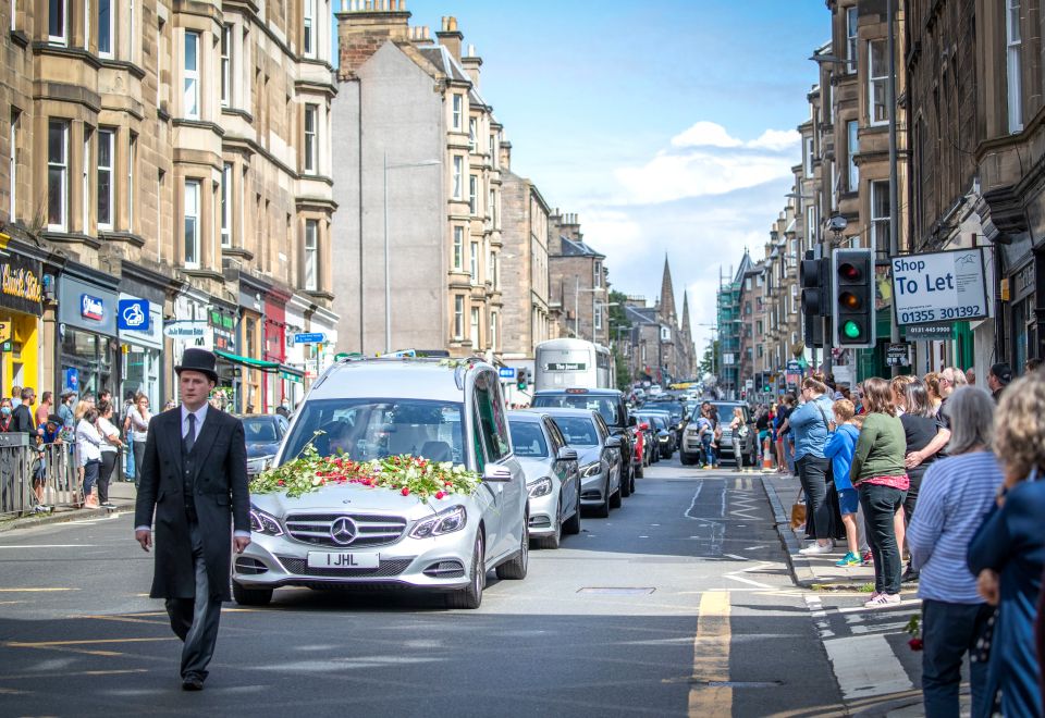 Mourners gathered to pay their respects as the funeral procession drove by