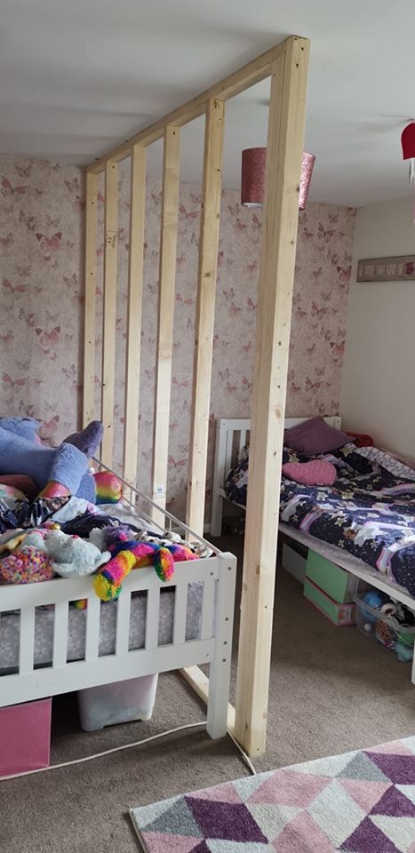  The partition wall makes two rooms out of one, allowing each girl to have their own bedroom