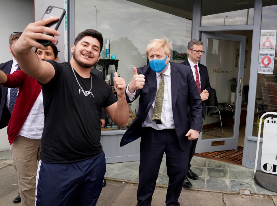 The PM poses with a fan in his constituency