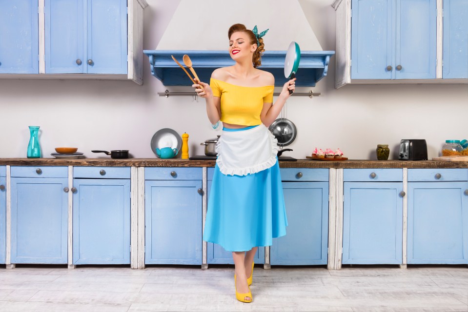 Retro pin housewife sitting in the kitchen