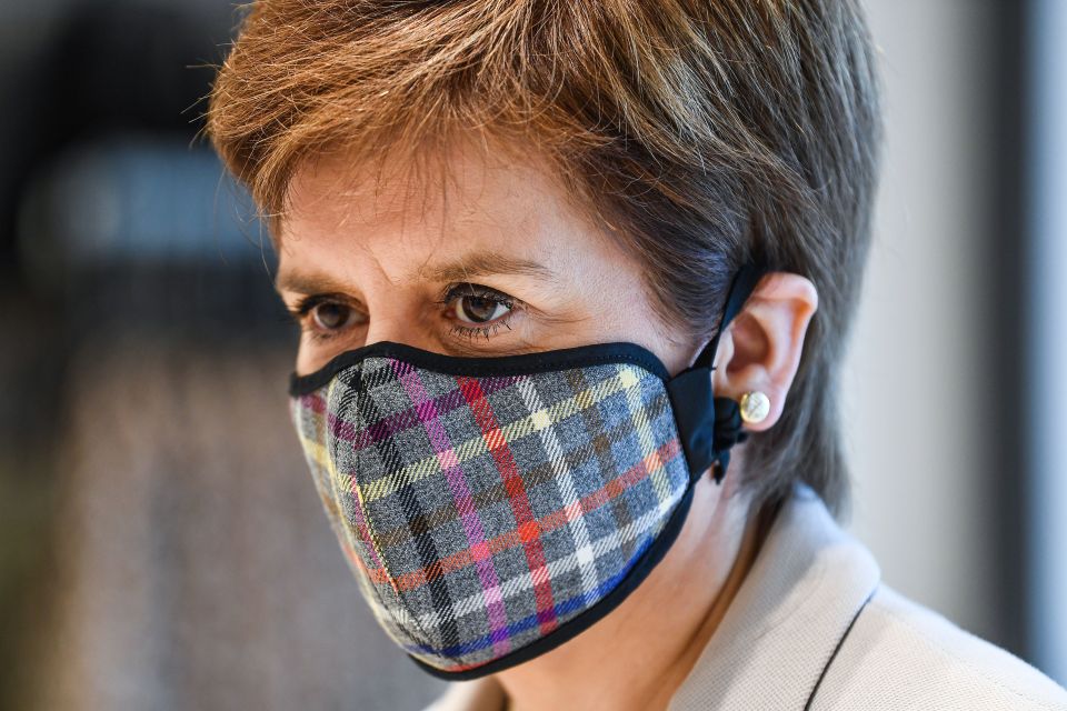 In Scotland, First Minister Nicola Sturgeon wearing a tartan face mask 