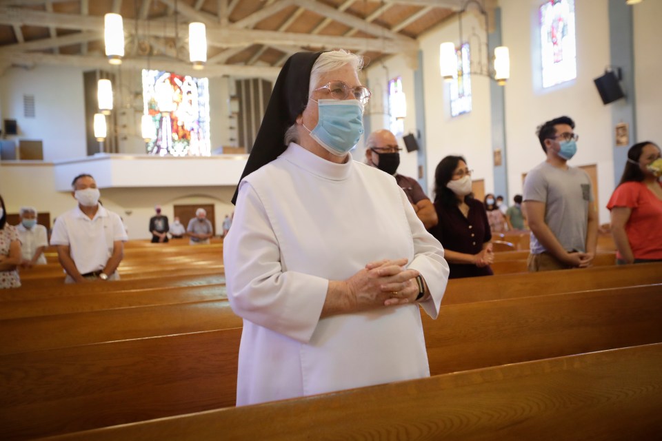 A nun attends a service at the San Gabriel Mission, California, July 12