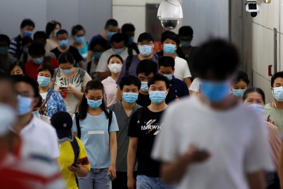 People walk at a subway station in Beijing