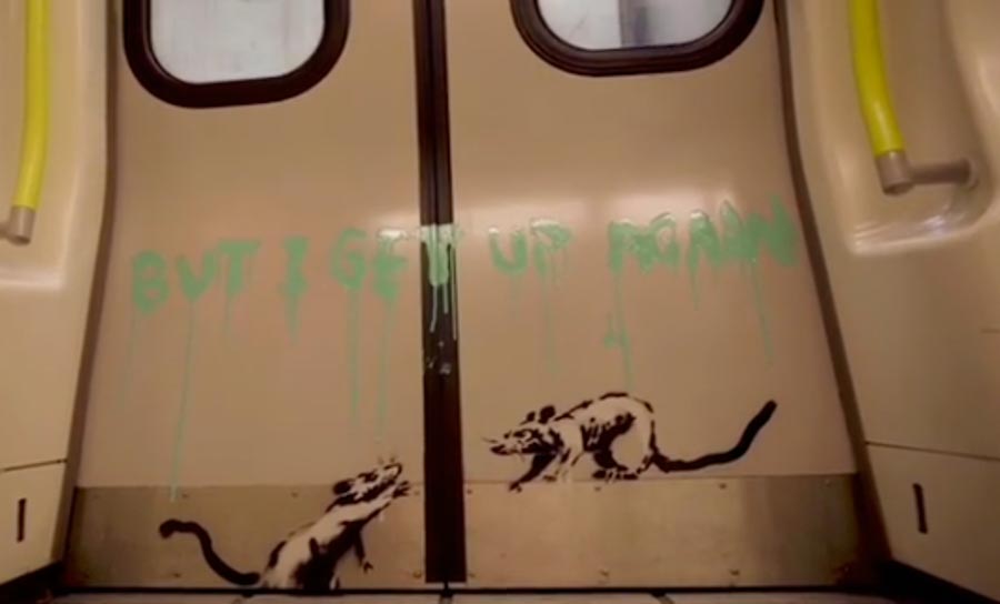 At the end of the video, the slogan 'But I get up again' shows as Tube doors slowly close