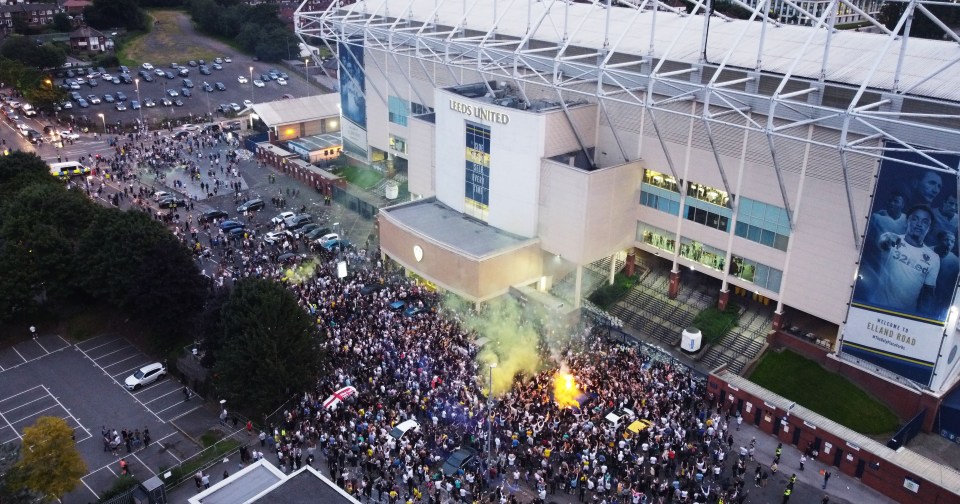  Leeds United fans celebrate in their thousands outside Elland Road