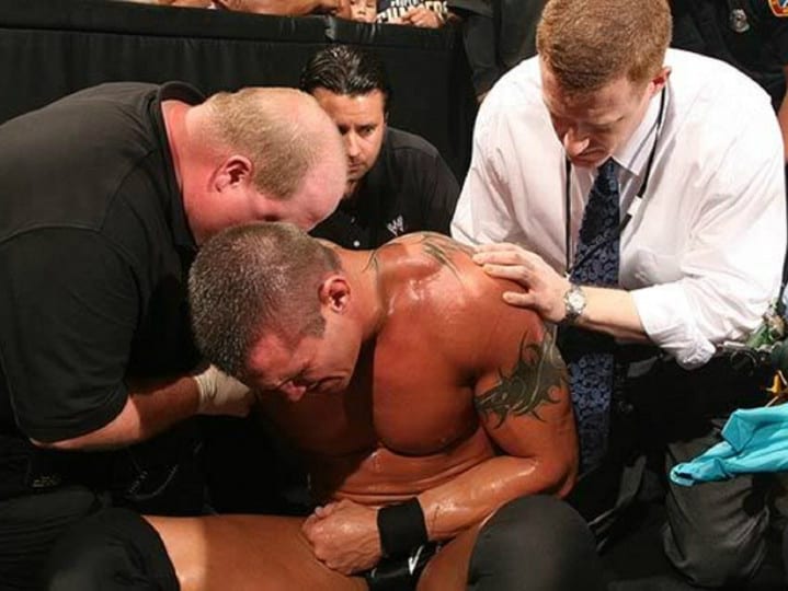 Doctors tend to Randy Orton after he broke his collarbone in the squared circle