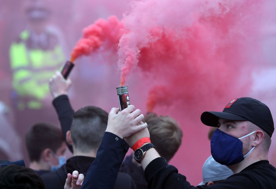 Flares were lit by fans as Liverpool made their way into Anfield