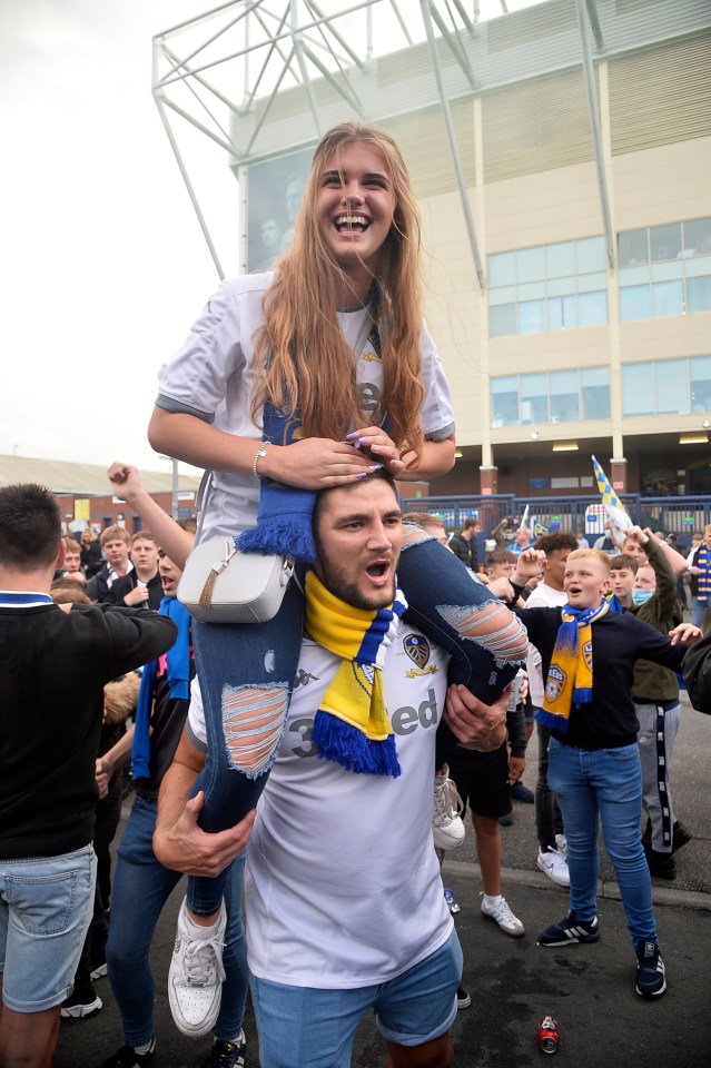 Leeds fans join in the celebrations outside their stadium