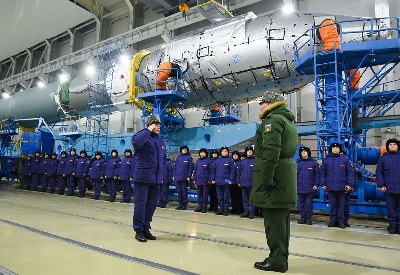 An officer takes a salute shortly before the launch