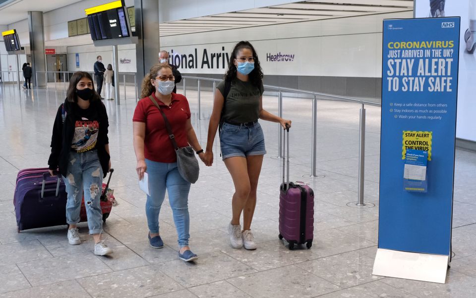 Holidaymakers arrive at Heathrow Airport from Madrid this morning