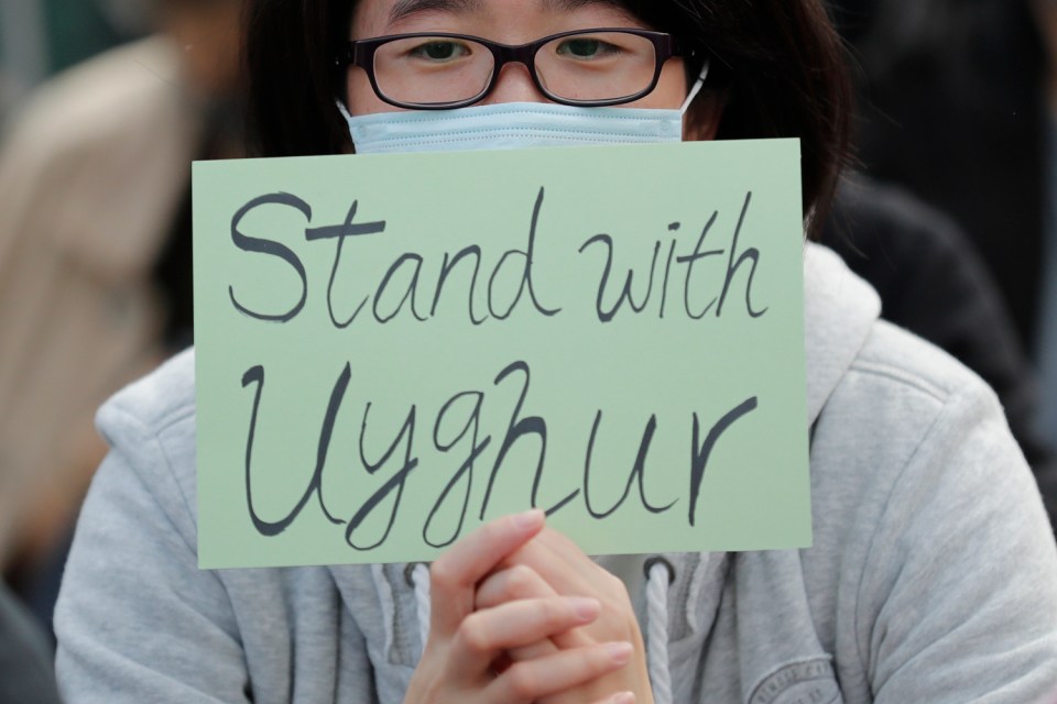 A sign reads "Stand with Uyghur" during a rally in Hong Kong