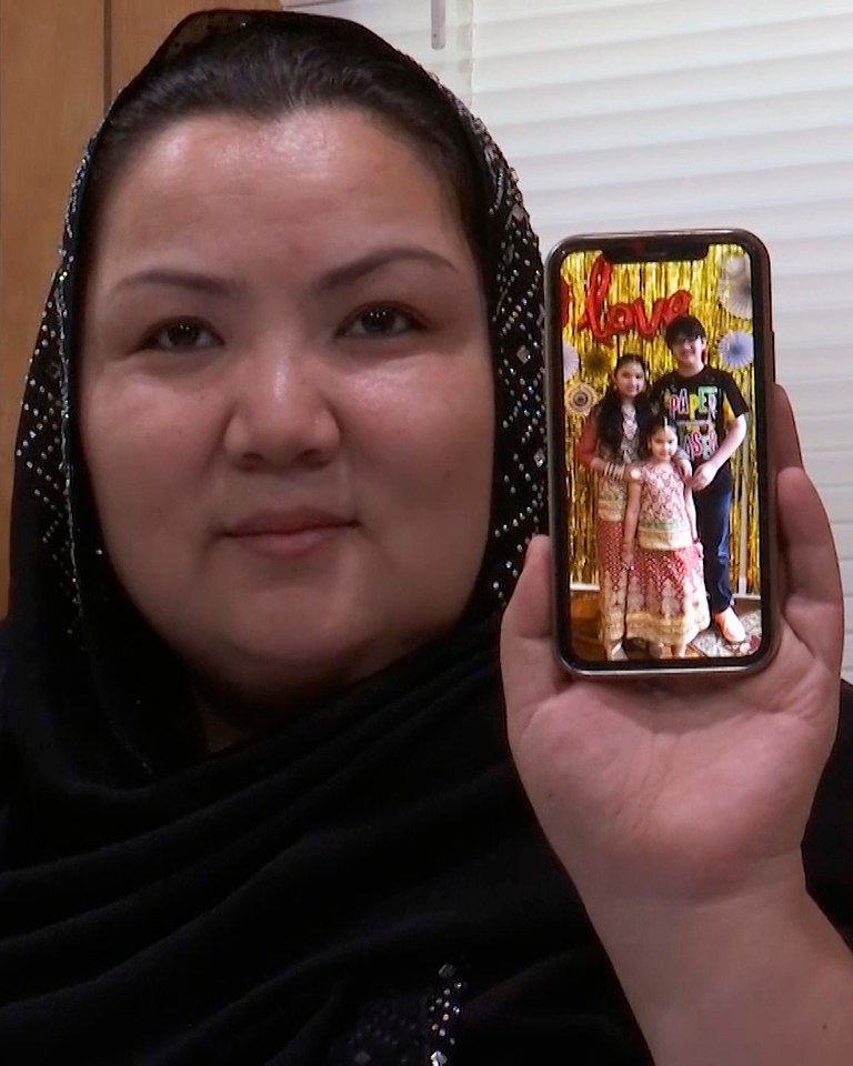 Zumret, seen holding a phone with a picture of her kids at her US home last month, was shackled and detained in 2018