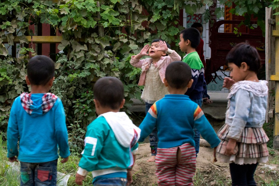 The Chinese government has been accused of carrying out a birth control campaign targeted at Uighurs, Kazakhs and other largely Muslim minorities. Above, Uighur children play outdoors in Hotan, Xinjiang