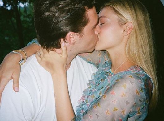 Brooklyn Beckham and his fiancée Nicola Peltz kiss after he popped the question