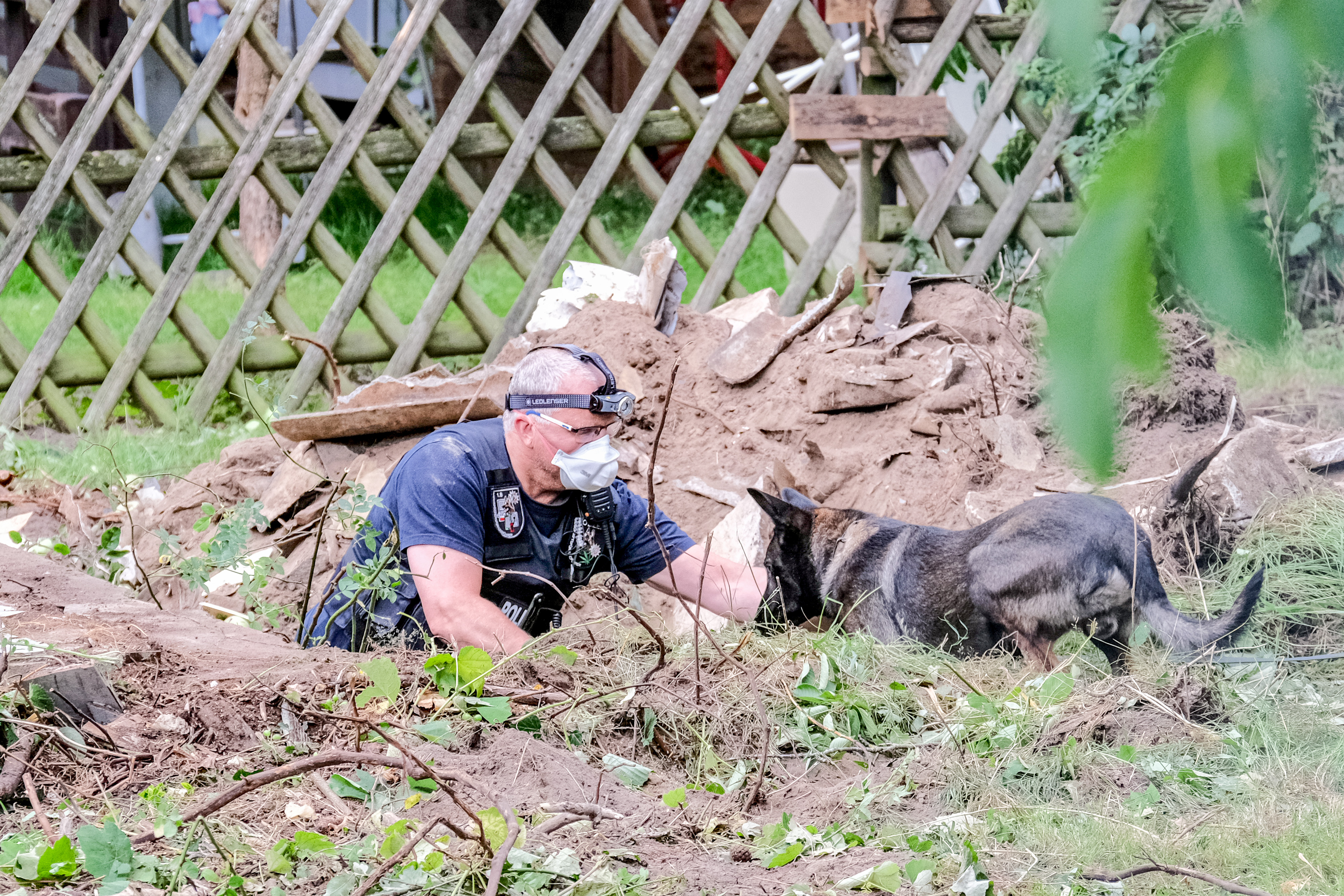 A German police officer with a sniffer dog at the allotment