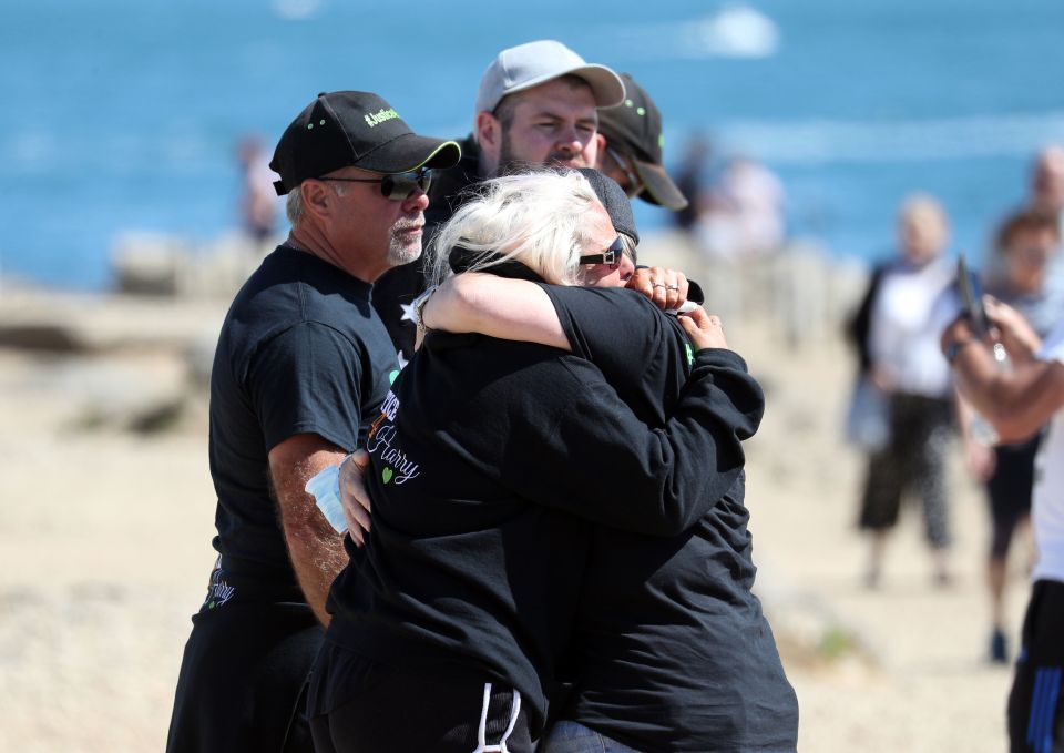 Harry's mum Charlotte hugged a friend as she prepared to scatter her son's ashes at Portland in Dorset today