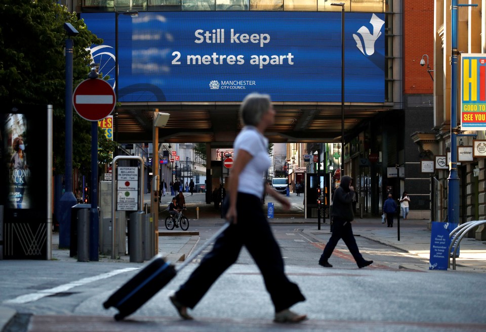 The new lockdown rules were brought in overnight, with a woman seen walking through Manchester