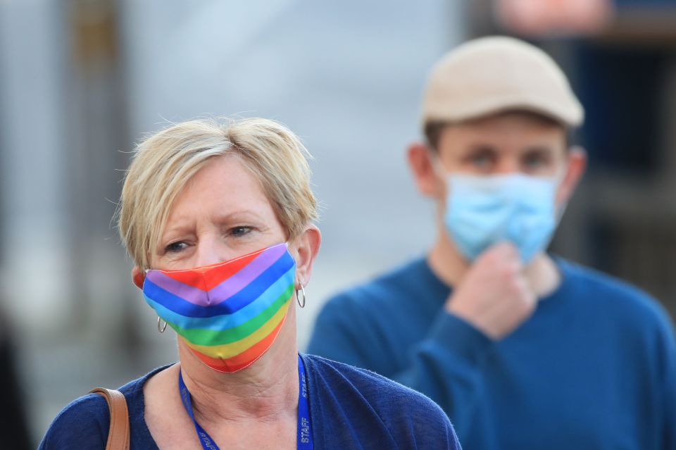 A woman wearing a face mask walks through the centre of Bradford, West Yorkshire, one of the areas where new measures have been implemented to prevent the spread of coronavirus