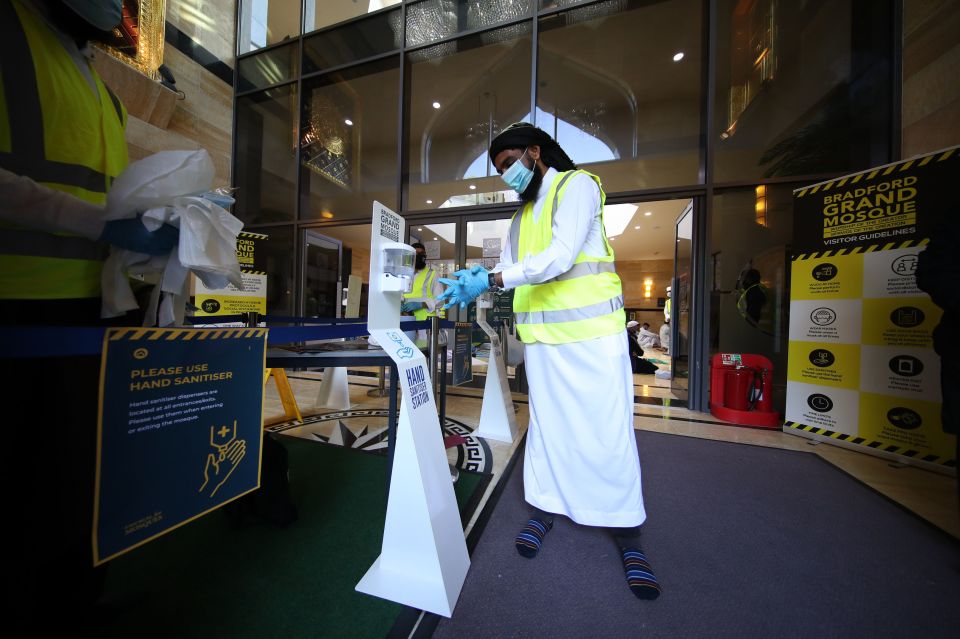 A worshipper uses hand sanitiser at the Bradford Grand Mosque on the first day of Eid in Bradford, West Yorkshire, one of the areas where new measures have been implemented