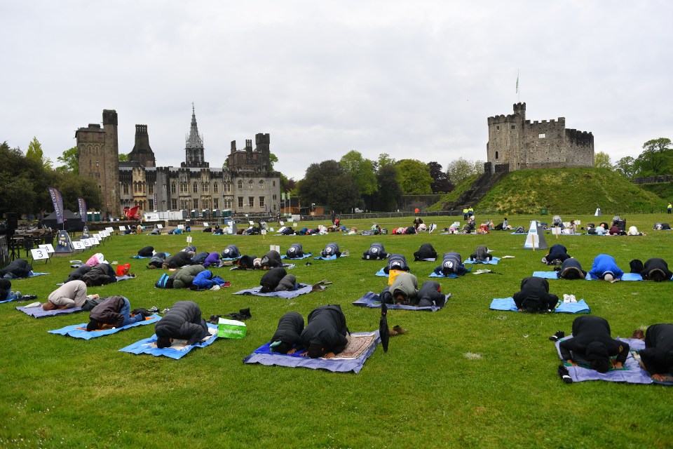 Muslim worshippers come together at Cardiff castle to hold Eid al-Fitr prayers on May 13, 2021