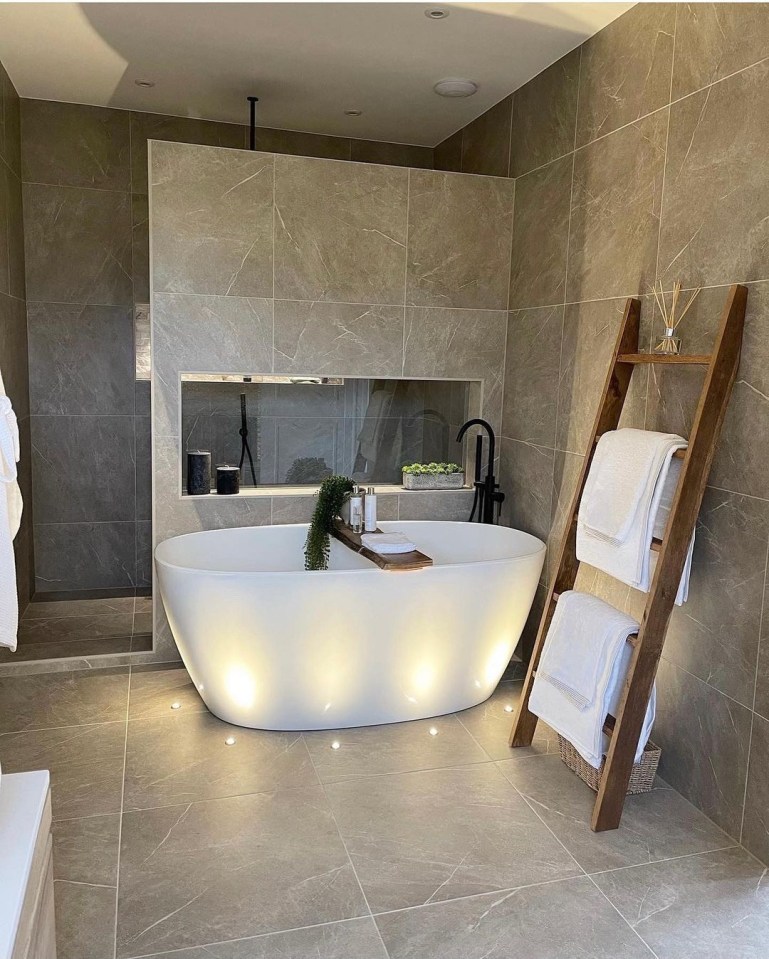  The master en-suite boasts a huge bathtub and lighting in the floor