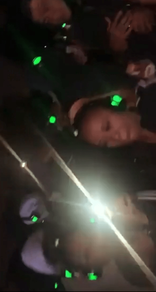 The party attendees all appear to be wearing fluorescent green headphones