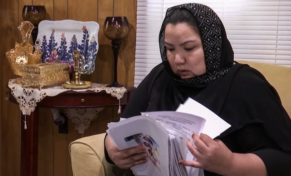  Zumret, pictured holding documents she brought with her to America, claims she received mysterious injections at the detention camp