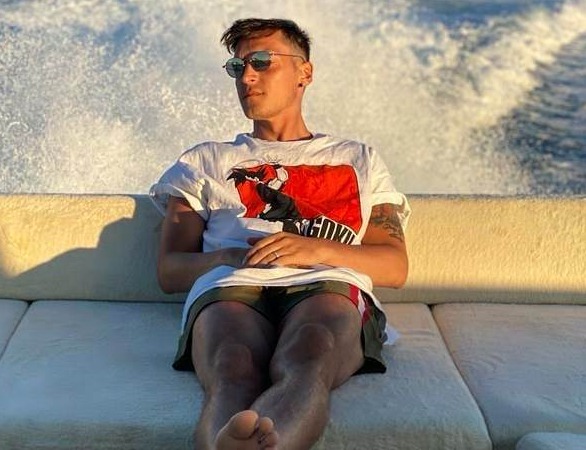 Mesut Ozil, seen her relaxing on a boat, has offered his congratulations to his Arzsenal team-mates after being left out of the Community Shield squad