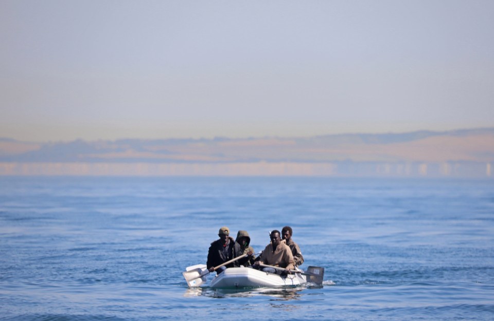 Four men use shovels as paddles in a bid to cross the English Channel in a small dinghy