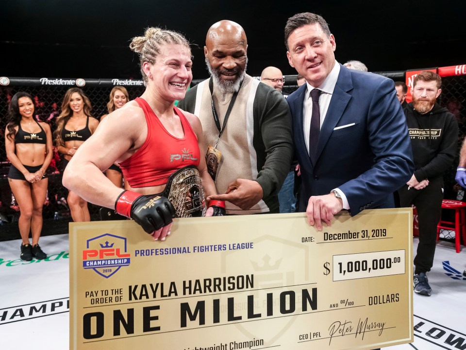 Mike Tyson handing PFL star Kayla Harrison a $1m winners cheque 