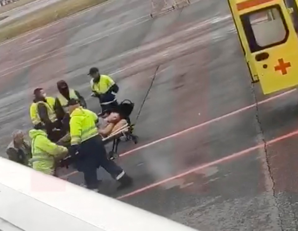 He was rushed from the plane to a waiting ambulance after collapsing