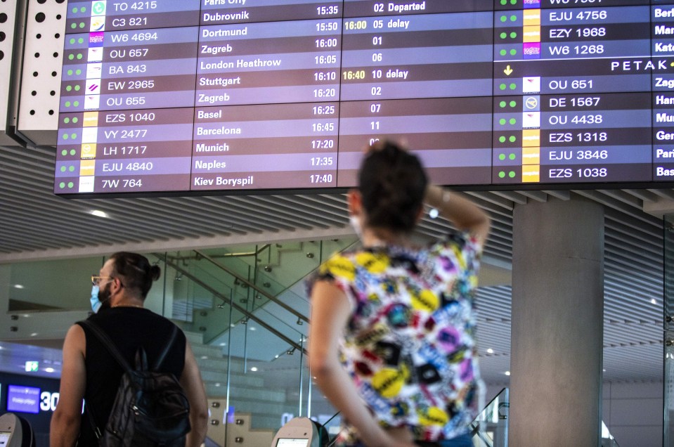 A woman checks departure boards at Split airport in Croatia