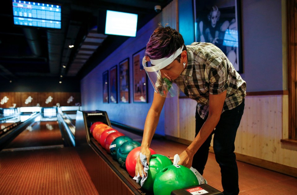 Bowling balls are cleaned between games at All Star Lanes at London's Westfield White City