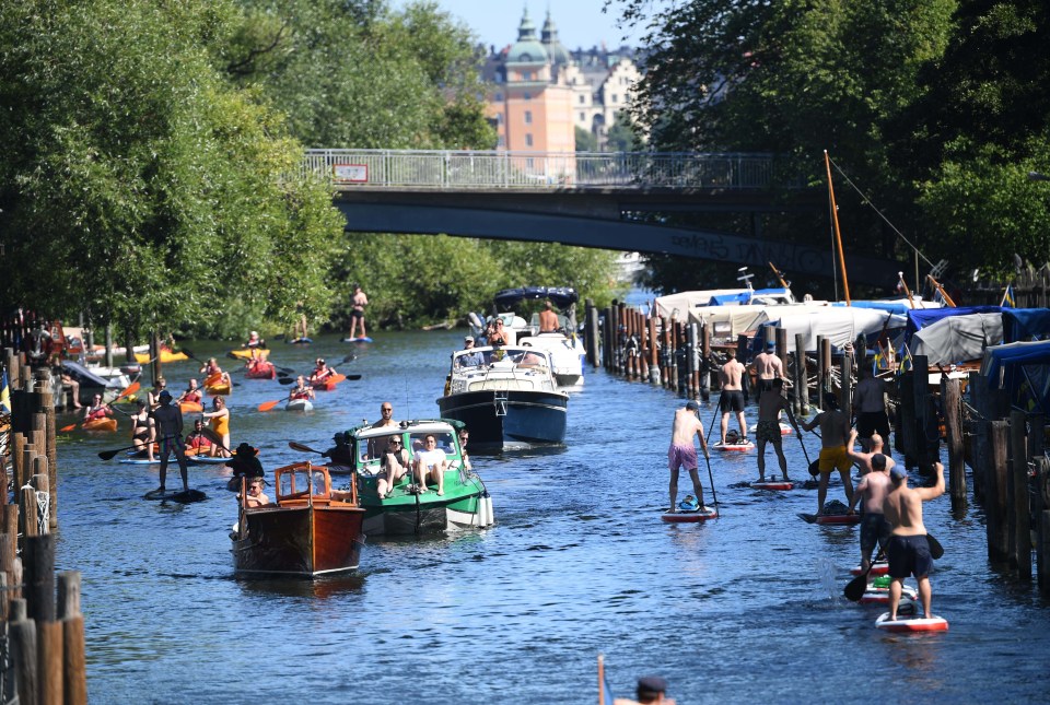 People enjoy boat rides, canoe paddling and stand-up paddling in the Palsund canal in Stockholm